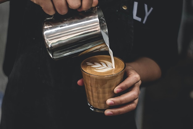 Person learning coffee brewing techniques with accessible guides